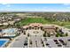 Aerial of a community clubhouse with a pool, tennis courts, and ample parking at 27290 E Nova Cir, Aurora, CO 80016