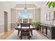 Formal dining room featuring a large window, chandelier, wood floors, and ample space for entertaining at 27290 E Nova Cir, Aurora, CO 80016