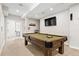 Spacious game room features a well-maintained pool table with equipment and a TV for entertainment at 27290 E Nova Cir, Aurora, CO 80016