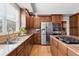 A view of kitchen features stainless steel appliances, granite countertops, and natural light from window at 27290 E Nova Cir, Aurora, CO 80016