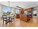 Eat-in kitchen with stainless steel appliances, ample counter space, island and hardwood floors at 27290 E Nova Cir, Aurora, CO 80016