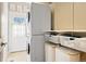 Well-organized laundry room featuring a stacked washer and dryer and ample storage shelves at 27290 E Nova Cir, Aurora, CO 80016