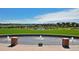 Lush community green space with a water feature, manicured lawn, and neighborhood homes in the background at 851 Elmhurst Dr # A, Highlands Ranch, CO 80129