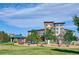 Community playground with slides, climbing structures, and a covered picnic area, surrounded by mature trees at 851 Elmhurst Dr # A, Highlands Ranch, CO 80129