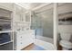 Updated bathroom with double vanity, subway tile shower, and linen shelving at 352 Apache Rd, Evergreen, CO 80439
