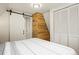 Bedroom featuring a barn door, closet and wood paneled accent wall at 352 Apache Rd, Evergreen, CO 80439