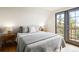 Bedroom features a bed with natural light from the door to the balcony at 352 Apache Rd, Evergreen, CO 80439