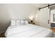 Cozy bedroom featuring a barn door and a lamp lit side table by the bed at 352 Apache Rd, Evergreen, CO 80439