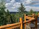 Deck showcasing wooden railings with scenic views of trees and mountains in the background at 352 Apache Rd, Evergreen, CO 80439