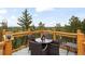Outdoor deck featuring a dining table set with forest view at 352 Apache Rd, Evergreen, CO 80439