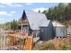 Charming cabin with two levels of decks and wooden stairs surrounded by tall trees at 352 Apache Rd, Evergreen, CO 80439