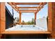 Inviting hot tub under a pergola with glasses nearby for ultimate relaxation at 352 Apache Rd, Evergreen, CO 80439