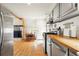 Open kitchen with butcher block counters and stainless steel appliances, leads to the dining area at 352 Apache Rd, Evergreen, CO 80439