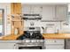 The kitchen features white cabinets, butcher block countertops, and stainless steel appliances at 352 Apache Rd, Evergreen, CO 80439