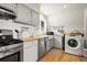 Bright kitchen with butcher block countertops, and a laundry area with washer and dryer at 352 Apache Rd, Evergreen, CO 80439