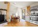 Cozy kitchen and dining area with a wood burning fireplace and a door to the outside at 352 Apache Rd, Evergreen, CO 80439