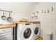 Convenient laundry area with side by side washer and dryer and butcher block folding area at 352 Apache Rd, Evergreen, CO 80439