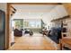 Bright living room with a stone fireplace, large windows, and nature views at 352 Apache Rd, Evergreen, CO 80439