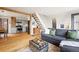 Open-concept living room and kitchen with wood floors and bright natural light at 352 Apache Rd, Evergreen, CO 80439