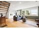Living room with open floor plan and staircase, wooden accents and comfortable seating at 352 Apache Rd, Evergreen, CO 80439