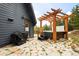 Back patio featuring a hot tub with pergola, and a grill for outdoor cooking at 352 Apache Rd, Evergreen, CO 80439