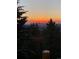 Beautiful sunset view over the mountains surrounded by pine trees at 352 Apache Rd, Evergreen, CO 80439