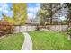 Large backyard with a walkway, grass lawn, a wooden fence, and mature trees at 11687 Decatur Dr, Westminster, CO 80234