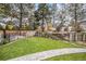 Lush green backyard with a stone walkway, wood fence, and tiered garden beds at 11687 Decatur Dr, Westminster, CO 80234