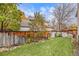 Lush backyard with a well-manicured lawn and a wooden fence, creating a serene and private outdoor space at 11687 Decatur Dr, Westminster, CO 80234