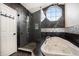 Modern bathroom featuring a glass enclosed shower, and soaking tub under an octagonal window at 11687 Decatur Dr, Westminster, CO 80234