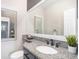 Bathroom featuring a granite countertop, framed mirror, stylish fixtures, and decorative accents at 11687 Decatur Dr, Westminster, CO 80234