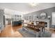 Bright open concept dining room with modern lighting, fireplace, and access to kitchen at 11687 Decatur Dr, Westminster, CO 80234