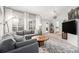 Spacious living room featuring neutral tones, a plush sectional, and sliding glass doors at 11687 Decatur Dr, Westminster, CO 80234