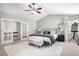 Spacious bedroom with plush carpet, a ceiling fan, and access to closet storage at 11687 Decatur Dr, Westminster, CO 80234