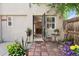 Back patio with an open doorway, plants, outdoor seating and brick flooring at 1532 N High St # 1, Denver, CO 80218