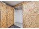 Unfinished basement with pipes and a door made of plywood with numbers on them at 1532 N High St # 1, Denver, CO 80218