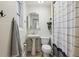 Compact bathroom with pedestal sink, toilet and shower-tub combination with patterned curtain at 1532 N High St # 1, Denver, CO 80218