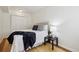 Bedroom with hardwood floors, white walls, closet, and decorative throw at 1532 N High St # 1, Denver, CO 80218