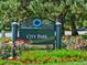 City Park sign surrounded by vibrant flowers, lush greenery, and mature trees, offering a serene urban oasis at 1532 N High St # 1, Denver, CO 80218