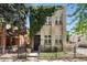 Charming two-story home with brick accents, lush ivy, and a secure wrought iron fence at 1532 N High St # 1, Denver, CO 80218