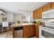 Updated kitchen with wood cabinets, stainless steel dishwasher, electric range and granite countertops at 1532 N High St # 1, Denver, CO 80218