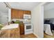 Charming kitchen area with a view to the living space, microwave, and electric range at 1532 N High St # 1, Denver, CO 80218