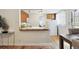 Efficient kitchen with butcher block counters and white appliances, blending into the bright living area at 1532 N High St # 1, Denver, CO 80218