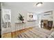 Bright living room with hardwood floors with an open concept kitchen and a bathroom down the hall at 1532 N High St # 1, Denver, CO 80218