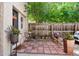 Back patio featuring brick flooring, a table and chairs, and decorative plants at 1532 N High St # 1, Denver, CO 80218