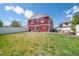 View of the home's backyard, featuring a spacious lawn, patio area, and privacy fence at 5552 Odessa St, Denver, CO 80249