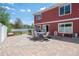 Large backyard with patio, outdoor furniture, and views of the home's exterior at 5552 Odessa St, Denver, CO 80249