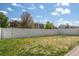 Large, sunny backyard with a well-maintained lawn and a privacy fence for outdoor enjoyment at 5552 Odessa St, Denver, CO 80249