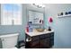 Bathroom featuring a modern vessel sink and silver framed mirror, creating an inviting space at 5552 Odessa St, Denver, CO 80249