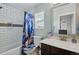 Bathroom with a shower and a bathtub features modern subway tiles at 5552 Odessa St, Denver, CO 80249